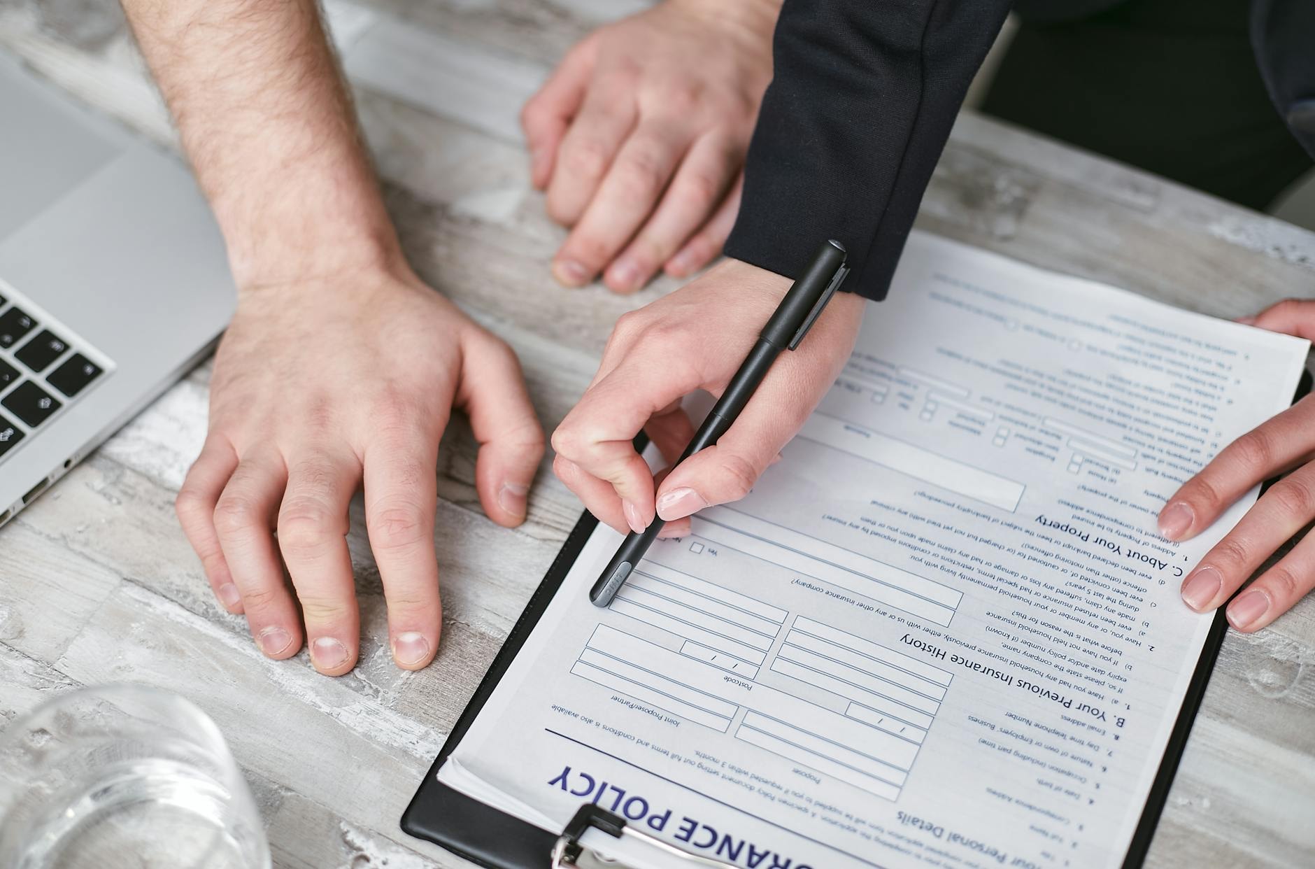 Person reviewing insurance policy documents at a desk